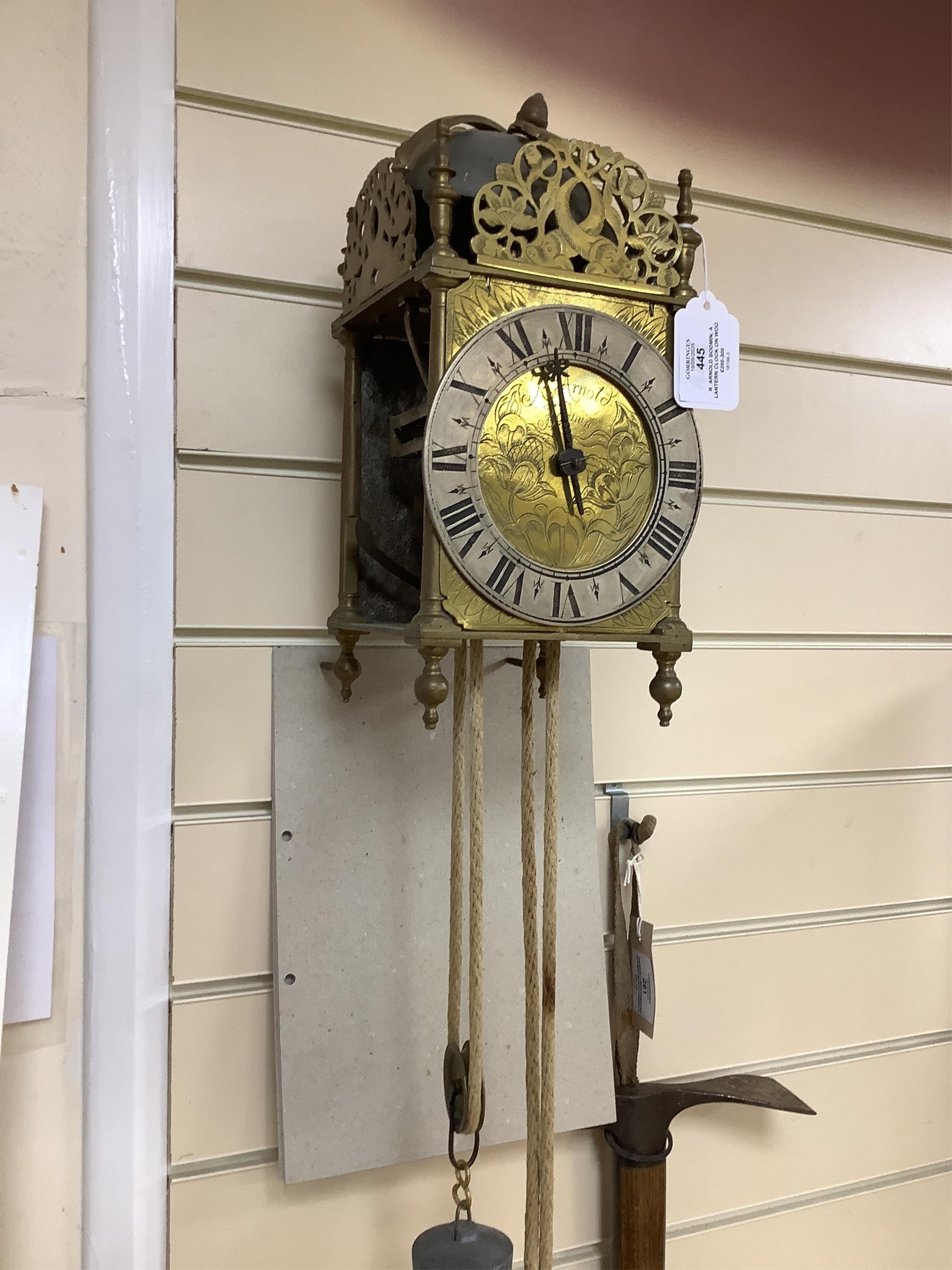 R. Arnold, Bodmin, a lantern clock on wooden wall shelf, clock 32cm high